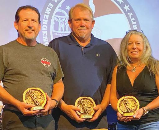 Brandon Griswell (l-r), Robbie Herndon and Tammy Herndon receive 10-year service awards. Daniel Fullmore and Robby Kern also earned the award.