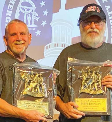Gary Harrell and Bobby Johnson receive their 25-year service awards.