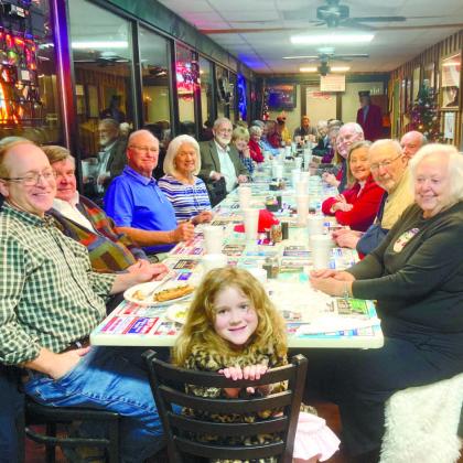 Olivia Wood is seated at the head of the table during the American Legion Post 142 Christmas Party held at Chevy’s Pizza Dec. 14. DEBBIE LURIE-SMITH/Staff